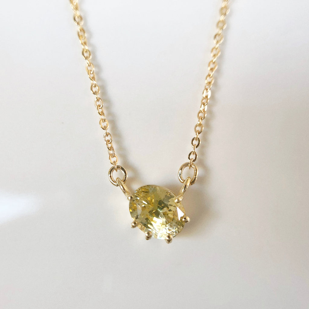 A bespoke gold necklace using a customer's own yellow sapphire