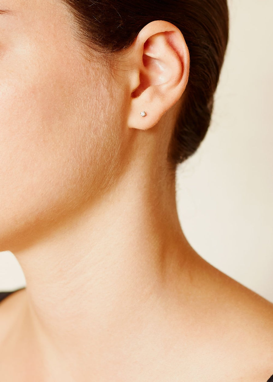 A model wearing a pair of 9ct Yellow Gold Stud Earrings with Champagne Diamonds